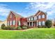 Brick two-story home with manicured lawn at 16404 Grassy Creek Dr, Huntersville, NC 28078