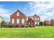 Two-story brick home with landscaped yard at 16404 Grassy Creek Dr, Huntersville, NC 28078