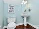 Small powder room with pedestal sink and decorative wall art at 16404 Grassy Creek Dr, Huntersville, NC 28078
