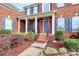 Grand entrance with brick facade and a covered porch at 16404 Grassy Creek Dr, Huntersville, NC 28078