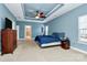 Main bedroom with a ceiling fan, dresser, and access to the bathroom at 16404 Grassy Creek Dr, Huntersville, NC 28078