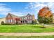 Brick two-story home with manicured lawn and landscaping at 16404 Grassy Creek Dr, Huntersville, NC 28078