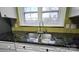 Close-up of the kitchen sink with stainless steel double basin and granite countertop at 18819 Cloverstone Cir, Cornelius, NC 28031