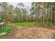 Spacious backyard with fire pit and seating area, surrounded by mature trees at 2224 Taylor Rd, Shelby, NC 28152