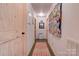 Bright hallway with light wood doors and a colorful quilt at 2224 Taylor Rd, Shelby, NC 28152