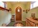 Inviting entryway with arched wood door, hardwood floors and antique furniture at 2224 Taylor Rd, Shelby, NC 28152