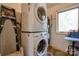 Stackable washer and dryer in a laundry room with additional storage at 2224 Taylor Rd, Shelby, NC 28152