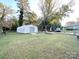 Spacious backyard with two metal storage buildings at 2310 Belfast Dr, Charlotte, NC 28208