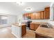 Bright kitchen with wood cabinets, island, and tile floor at 2318 Sweet Flag Ct, Charlotte, NC 28262