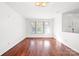 Living room with hardwood floors and large windows at 2318 Sweet Flag Ct, Charlotte, NC 28262