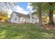 Home's backyard with trees, grass, and a white fence at 2702 New Hamlin Way, Charlotte, NC 28210