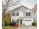 Two-story house with gray and beige siding, and a two-car garage at 5414 Barley Ln, Charlotte, NC 28216