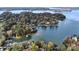 Aerial view showcasing lakefront homes with fall foliage at 119 Plantation Dr, Mooresville, NC 28117