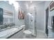 Modern bathroom with granite countertop, glass shower, and mosaic tile floor at 119 Plantation Dr, Mooresville, NC 28117