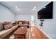 Bonus room features large TV, comfortable seating, and hardwood floors at 119 Plantation Dr, Mooresville, NC 28117