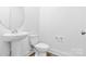 Simple bathroom with pedestal sink, toilet and a round mirror at 183 Sugar Hill Rd, Troutman, NC 28166