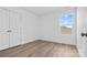 Bright bedroom with wood-look floors and a large window at 183 Sugar Hill Rd, Troutman, NC 28166