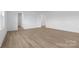 Large bedroom with wood-look floors and access to other rooms at 183 Sugar Hill Rd, Troutman, NC 28166