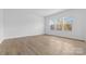 Spacious bedroom with three large windows offering ample natural light and wood floors at 183 Sugar Hill Rd, Troutman, NC 28166