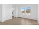 Bright bedroom with two windows, light wood floors, and a view of the backyard at 183 Sugar Hill Rd, Troutman, NC 28166