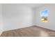 Simple bedroom with a large window, light wood floors, and neutral walls at 183 Sugar Hill Rd, Troutman, NC 28166