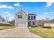Two-story house with a gray exterior, two-car garage, and a well-maintained lawn at 183 Sugar Hill Rd, Troutman, NC 28166