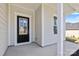 Covered front porch with black front door at 183 Sugar Hill Rd, Troutman, NC 28166