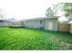 Green grassy backyard with deck and exterior storage at 4039 Uppergate Ln, Charlotte, NC 28215