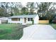 Newly renovated ranch home with a modern facade and landscaped lawn at 4039 Uppergate Ln, Charlotte, NC 28215