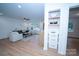 Bright living room with hardwood floors and built-in shelving at 4039 Uppergate Ln, Charlotte, NC 28215