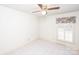 Bright bedroom with ceiling fan, window, and neutral carpeting at 5419 Doncaster Dr, Charlotte, NC 28211