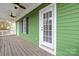 Back exterior showing green house and deck at 14108 Tooley St, Huntersville, NC 28078