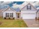 Exterior view of a two-bedroom home with attached garage at 1664 Amberlight Cir, Salisbury, NC 28144