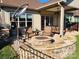 Outdoor patio with fire pit, seating area, and covered pergola at 171 Chimney Rock Ct, Denver, NC 28037