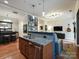 Open kitchen island with granite countertops, integrated sink and dishwasher at 230 S Tryon St # 205, Charlotte, NC 28202