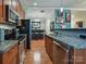 Modern kitchen featuring granite countertops and stainless steel appliances at 230 S Tryon St # 205, Charlotte, NC 28202