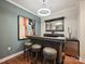Basement bar with custom cabinetry and stylish lighting at 230 S Tryon St # 205, Charlotte, NC 28202