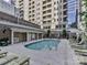 Inviting community pool with lounge chairs and surrounding brick at 230 S Tryon St # 205, Charlotte, NC 28202