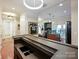 Modern home bar with dark wood cabinetry and granite countertop at 230 S Tryon St # 205, Charlotte, NC 28202