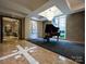 Shared music room with a grand piano at 230 S Tryon St # 205, Charlotte, NC 28202