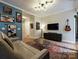Stylish living room with mid-century modern furniture and a large TV at 230 S Tryon St # 205, Charlotte, NC 28202