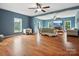 Bright living room featuring hardwood floors and a large TV at 826 Deer Path Pl, Mooresville, NC 28115