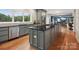 Modern kitchen with island, stainless steel appliances, and hardwood floors at 826 Deer Path Pl, Mooresville, NC 28115