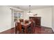 Bright dining room features hardwood floors and elegant chandelier at 9511 Eagle Feathers Dr, Charlotte, NC 28214