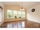 Bright breakfast room with hardwood floors and large windows at 9693 Brandybuck Nw Dr, Charlotte, NC 28269