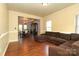 Spacious living room with hardwood floors and large windows at 9693 Brandybuck Nw Dr, Charlotte, NC 28269