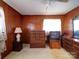 Bedroom with wood paneled walls, ceiling fan, and vintage furniture at 1869 Emma Cir, Lancaster, SC 29720