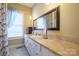 Bright bathroom with vanity, large mirror, and tiled floor at 402 W 7Th St, Newton, NC 28658