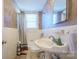 Clean bathroom with pedestal sink, tub, and shower at 402 W 7Th St, Newton, NC 28658