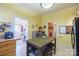 Galley kitchen with wood cabinets, stainless steel appliances, and access to laundry and mudroom at 402 W 7Th St, Newton, NC 28658
